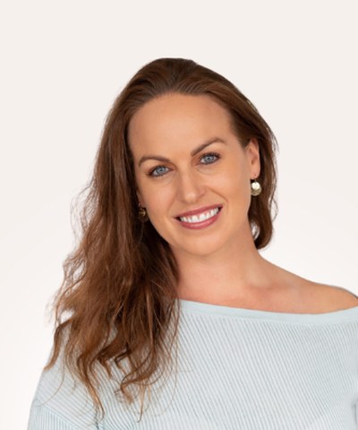Marlie Jolanda, smiling, in a soft blue top