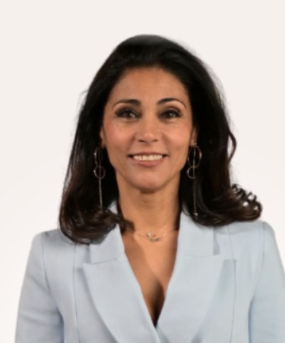 Sara Love, smiling, in a pale blue blazer